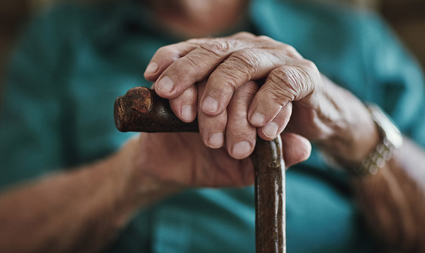 Patient with a cane receiving home-based care from Advisacare home health from a work related injury.