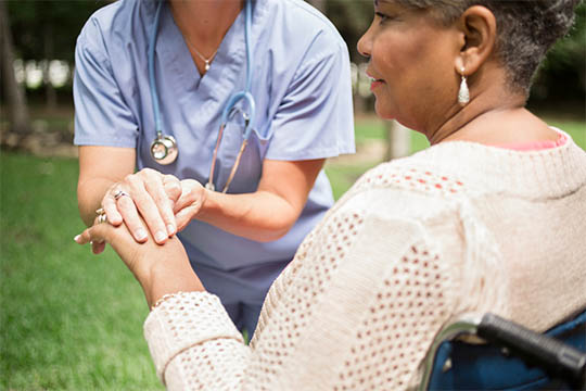 Catastrophic care patient receiving comfort outdoors from an Advisacare Home Health nurse